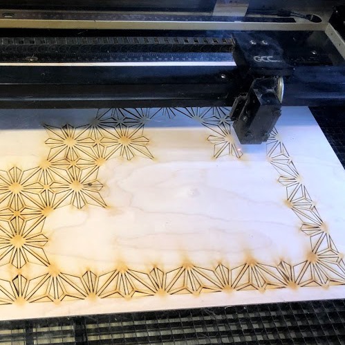 Wood on laser bed being engraved