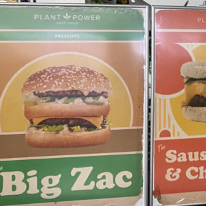 Two large printed signs for a restaurant