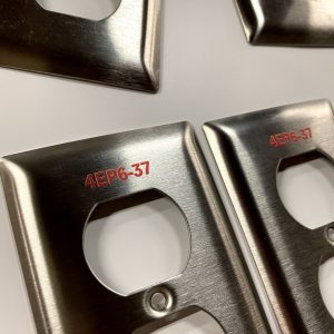 Laser marked switch plates
