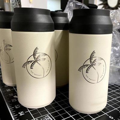 Engraved Tumblers with black tops being prepared